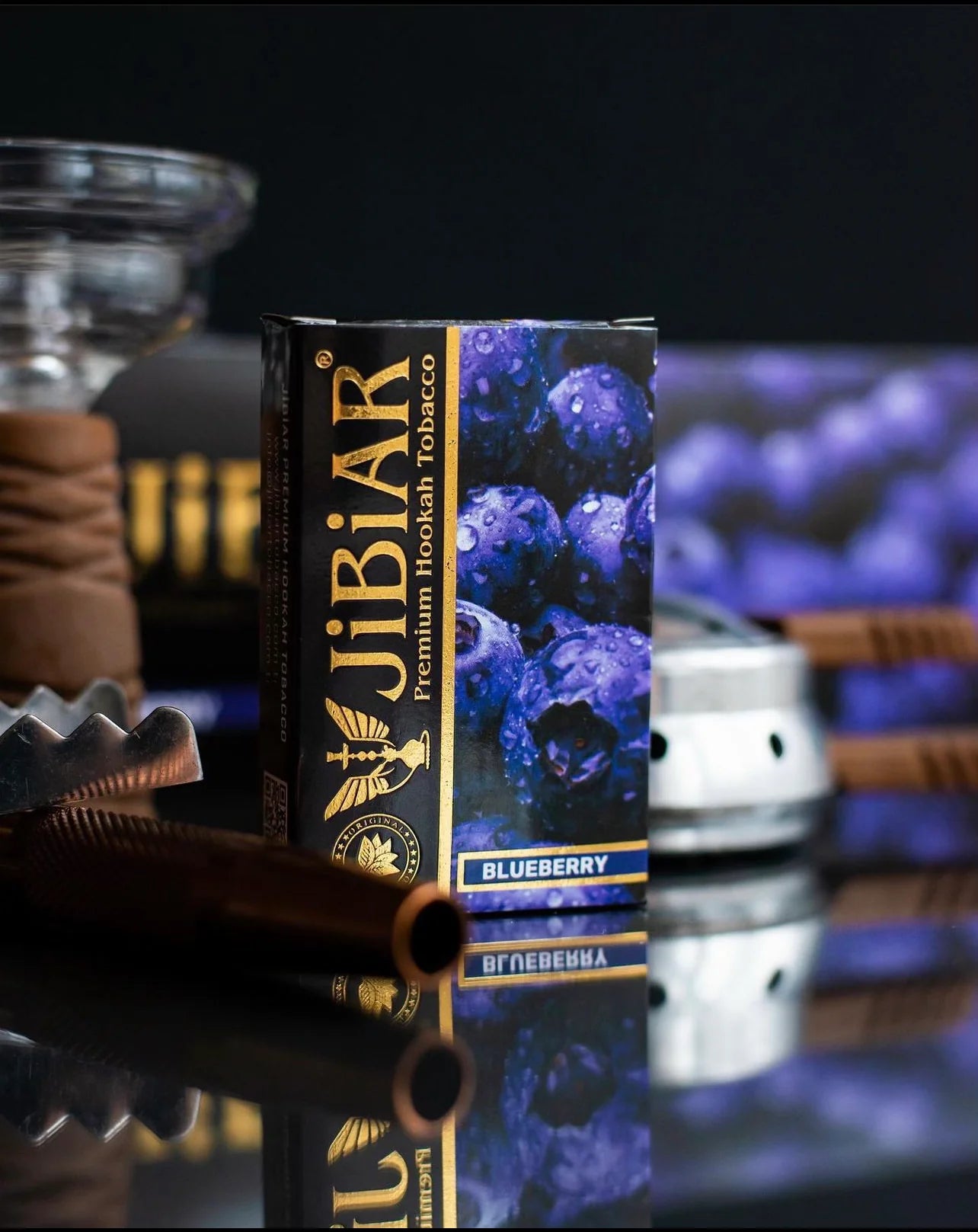 Jibiar blueberry tobacco packaging with smoking accessories in the background