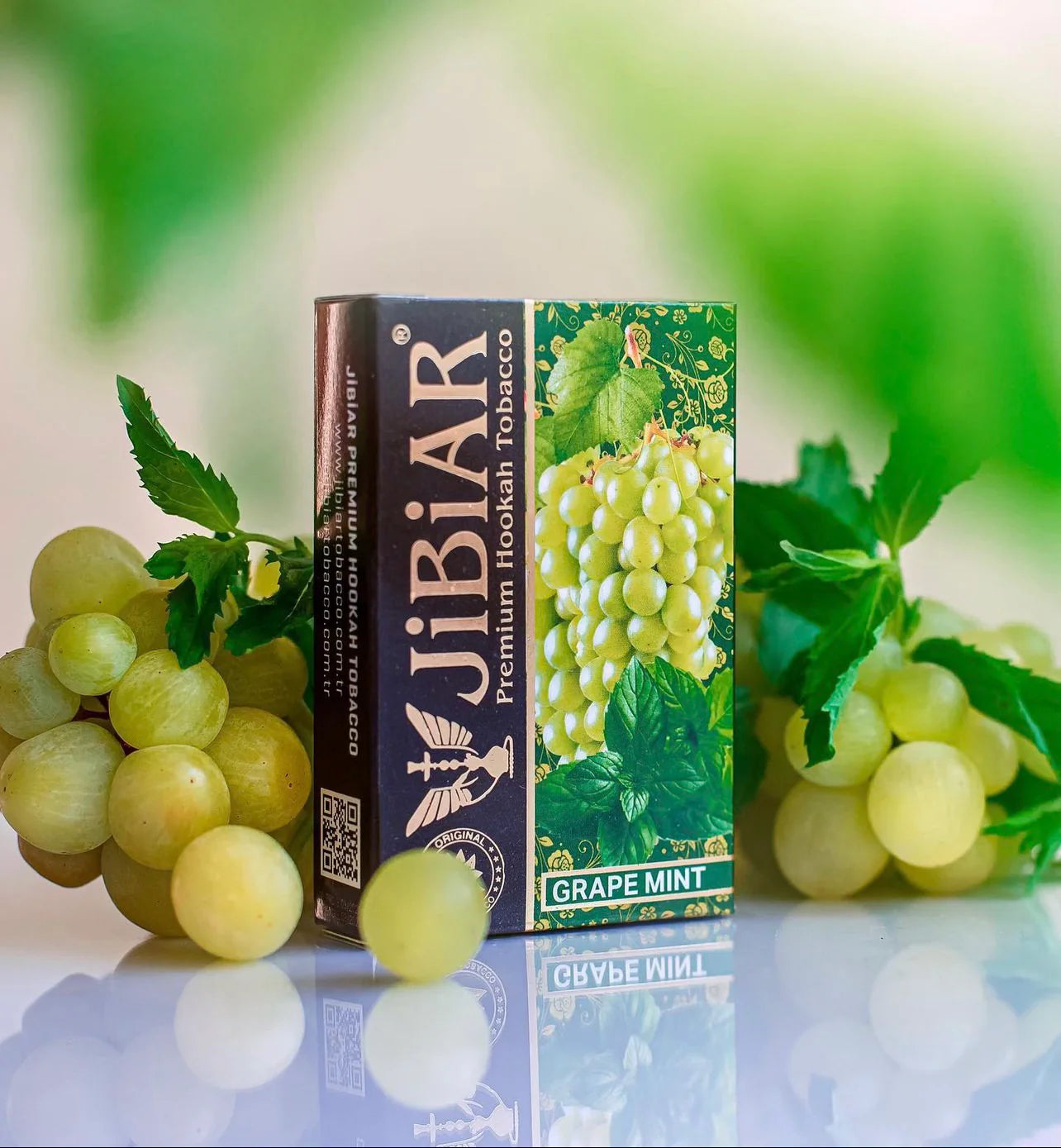 JiBiAR grape mint hookah tobacco packaging with grapes on a reflective surface