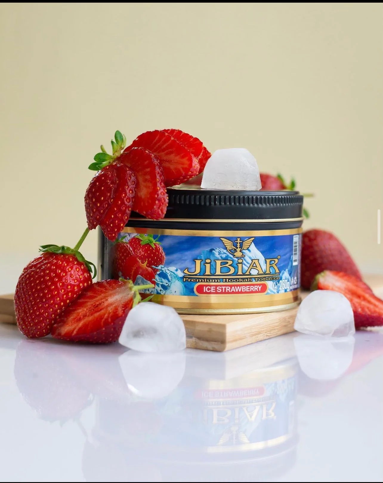 Jibiar Ice Strawberry product with strawberries and ice cubes on a reflective surface